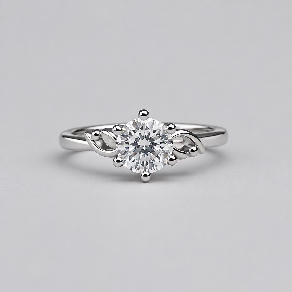 A silver ring with a clear central gemstone and decorative side stones, displayed in front of a white jewelry box with an orange 'M' logo on a dark gray background.