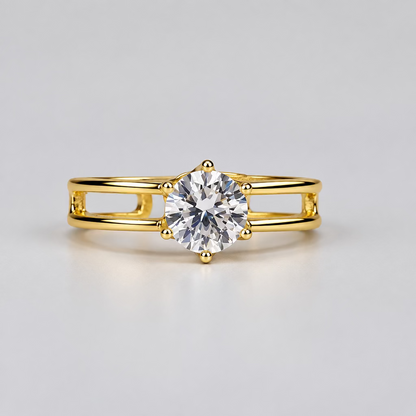 A rose gold ring with a clear central gemstone and small side stones, displayed in front of its white Meenu jewelry box on a light surface.