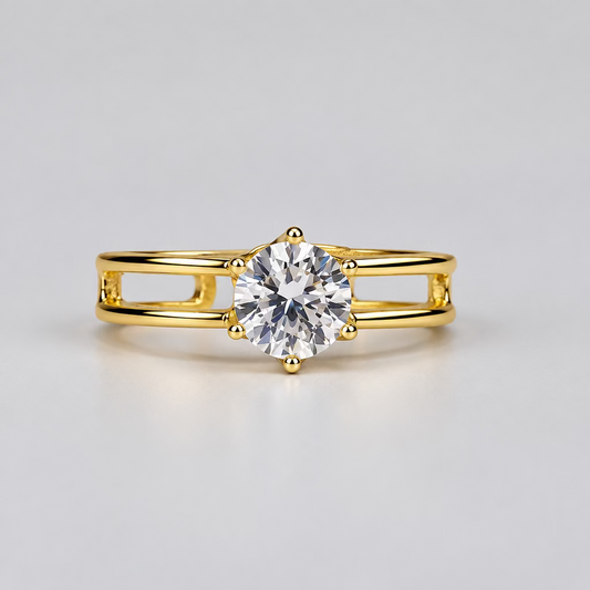 A rose gold ring with a clear central gemstone and small side stones, displayed in front of its white Meenu jewelry box on a light surface.