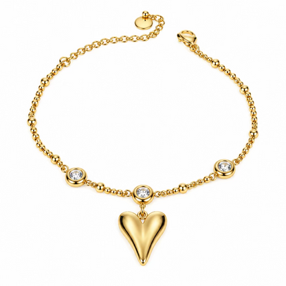 A delicate gold chain bracelet featuring a central black heart pendant and small metallic bead accents, displayed on a plain white surface.