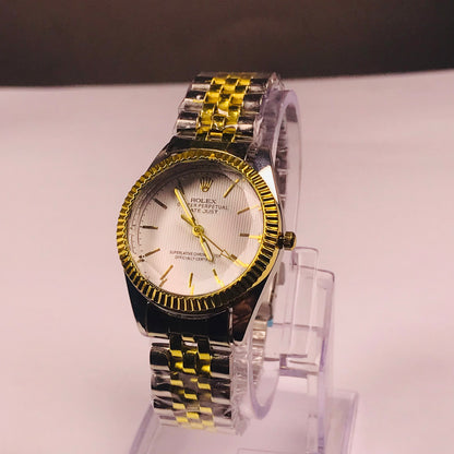 Rolex Datejust watch with a two-tone silver and gold metal bracelet, a gold fluted bezel, and a white dial, displayed on a clear acrylic stand.