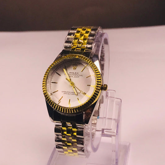 Rolex Datejust watch with a two-tone silver and gold metal bracelet, a gold fluted bezel, and a white dial, displayed on a clear acrylic stand.